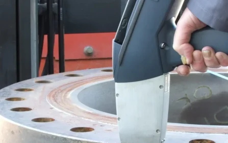 Technician performing field metallography on metal surface